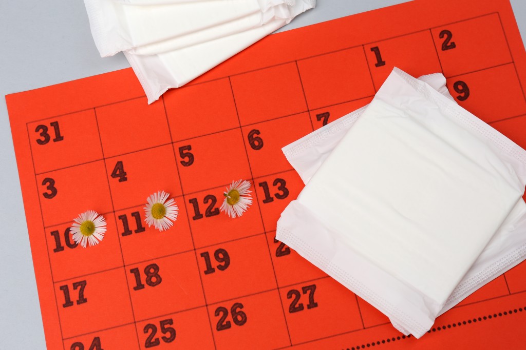 A calendar with daisy stickers used to track menstruation